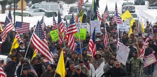 Armed protesters refuse to leave