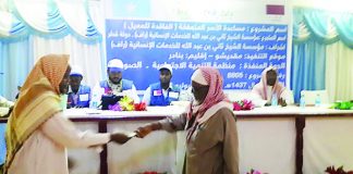 A Somali citizen receiving money from a RAF representative in a ceremony in capital Mogadishu