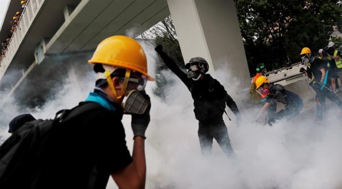 Defying police ban, HK protesters return to gang-attack scene