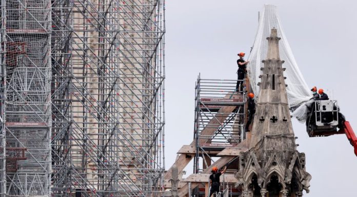Workers start to remove charred scaffolding around Notre-Dame Cathedral