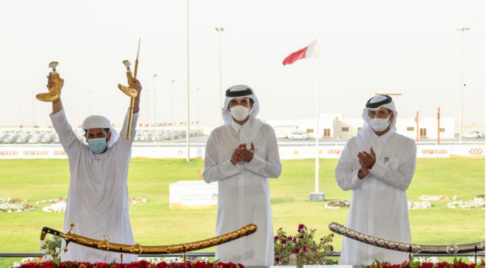 His Highness crowns the winners at the end of the Purebred Arabian Camel Festival on the sword of His Highness