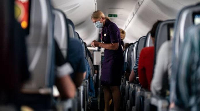 Delta Air Lines is raising health insurance premiums for unvaccinated employees by $200 a month to cover higher Covid costs
