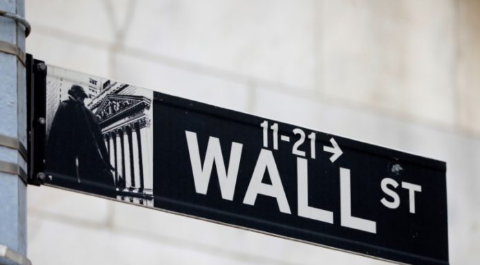 Wall Street hits records on economic optimism; dollar falls