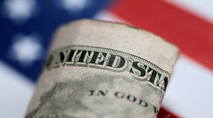 Dollar ticks lower with Fed policy decision in focus