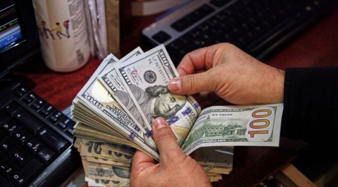 Dollar hits one-week high on hawkish Fed views, Omicron fears; Aussie slides