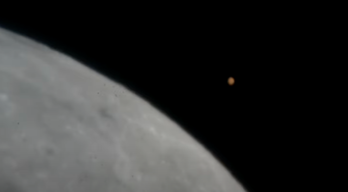 Mars shines bright in night sky as it vanishes behind moon