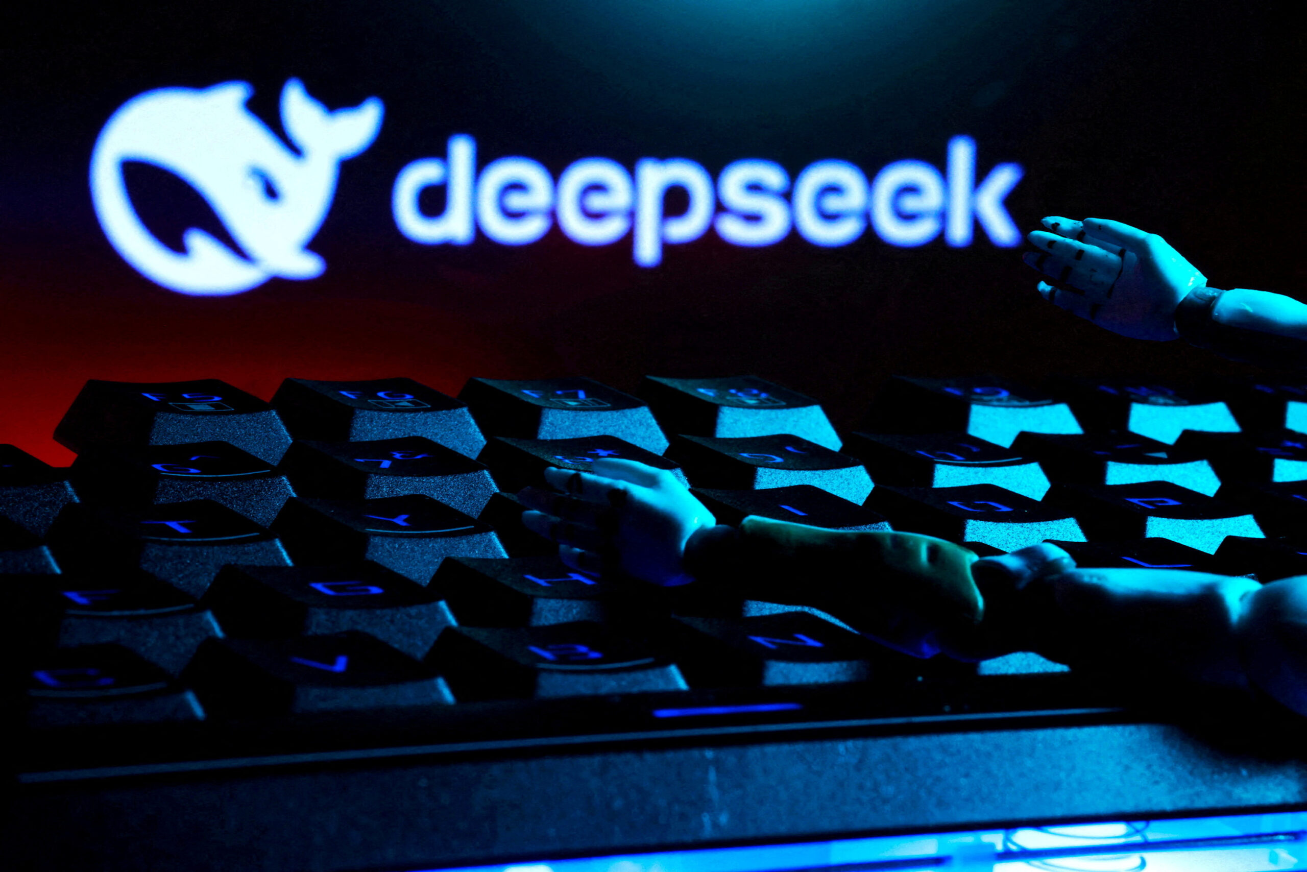 FILE PHOTO: Illustration shows deepseek logo, keyboard, and robot hands